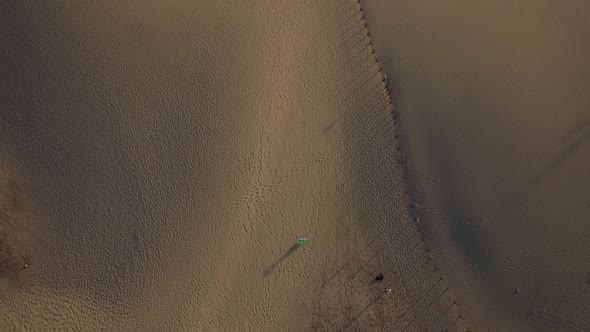 Flying Over Woman with Brazilian Flag on the Ocean Coast