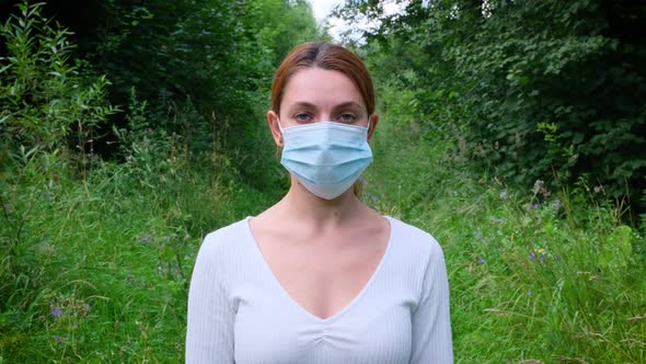 Pandemic, Portrait of a Young Woman Wearing Protective Mask on Park. Covid Concept and Safety