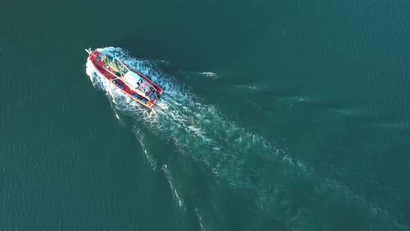 An aerial view from a drone flying above a fishing boat