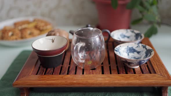 Teapot and Bowls Prepared for the Tea Ceremony on a Stand Made of Bamboo