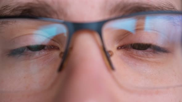 Close up of man's face glasses. Boy opening his beautiful eyes. European young male model green eyes