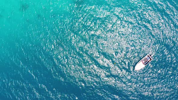 Aerial Top View of a Fishing Boat Sailing in Turquoise Waters of Ocean Zanzibar