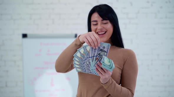 Happy woman counting banknotes