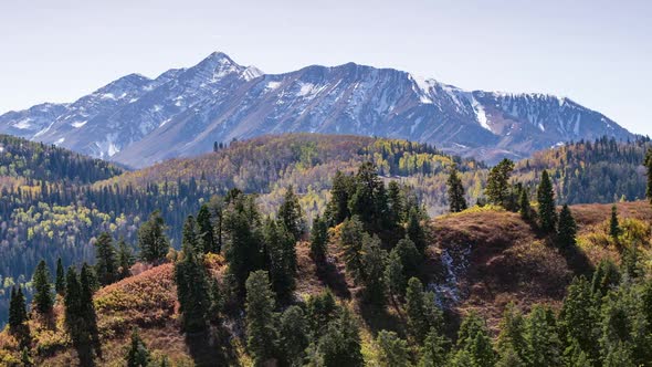 Panning aerial view of mountain layers in the Fall