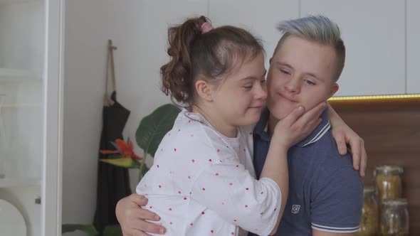 Young Couple with Down Syndrome In Love at Kitchen