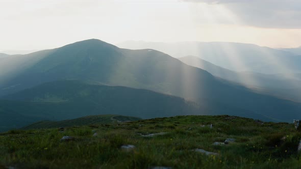 Timelaps Shot with Fast Moving Clouds in a Beautiful Green Valley of the Mountains in Sunset