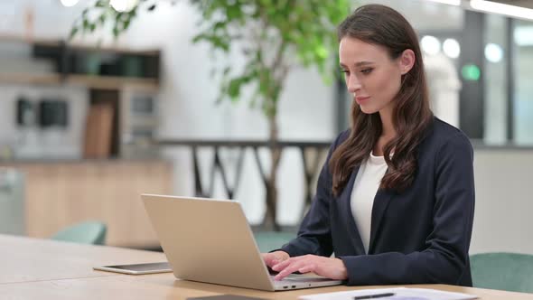 Young Businesswoman at Work Using Laptop