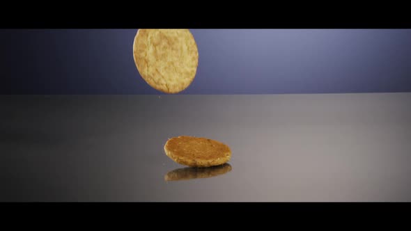 Falling cookies from above onto a reflective surface - COOKIES 