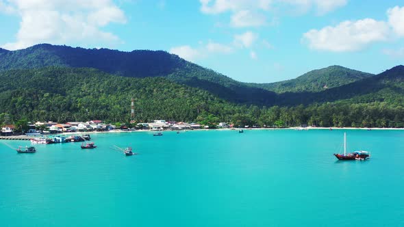 Koh Phangan, Thailand. Boats floating in the turquoise calm lagoon, Chaloklum bay.