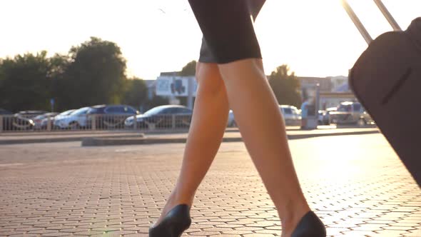 Business Woman Walking with Her Suitcase From Airport Hall or Waiting Room. Young Girl in Heels