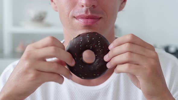 Glazed Donut with Chocolate on Man Hands