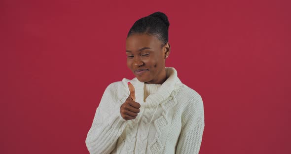 Portrait of Afro American Woman Model Stands in Studio on Red Background Wears White Sweater Girl