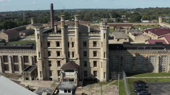 Aerial view of the derelict and abandoned Joliet prison or jail, a historic place. Drone rotating le