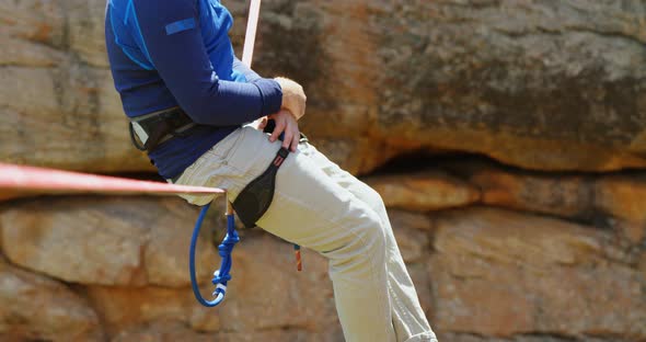 Mountaineer relaxing on the rope