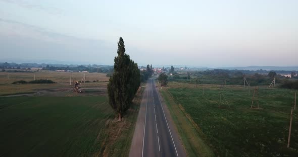 Country Road in the Morning Time, Oil Field Site, Oil Pumps Are Running.