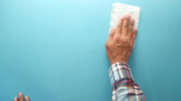 Top View of Person Hand Cleaning Table with Cloth