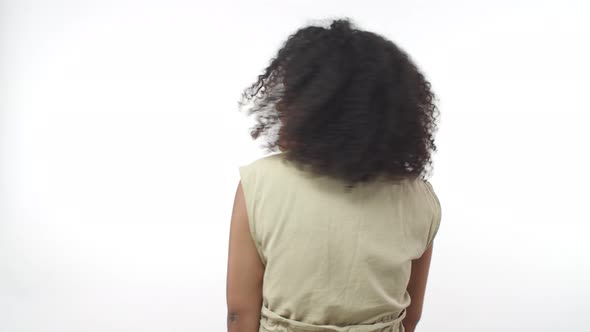 Sassy Upbeat Lively Africanamerican Teenage Girl with Afro Hairstyle Standing Back to Camera Turn
