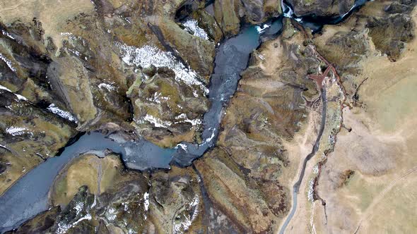 Drone rotating flying over winding River Canyon in Southern Iceland Countryside off Iceland Ring Roa