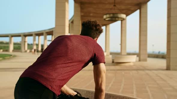 Attractive tall man in sportswear prepare to run while using his smart watch, shot in slow motion wi