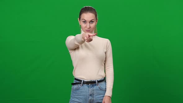 Serious Strict Woman Pointing at Camera Standing on Green Screen