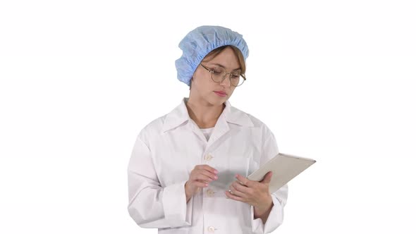 Young Positive Doctor Woman Taking Notes on Tablet and Walking on White Background