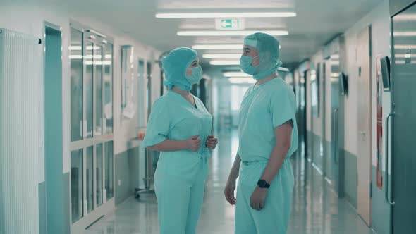 Two Surgeons are Talking in the Corridor of a Medical Ward