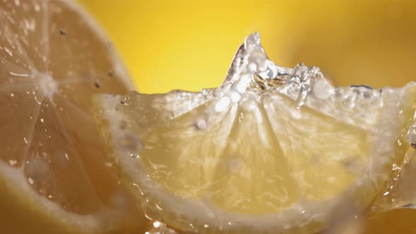 Slow Motion Shot of Lemon and Water Splashing Through Lemon Slices