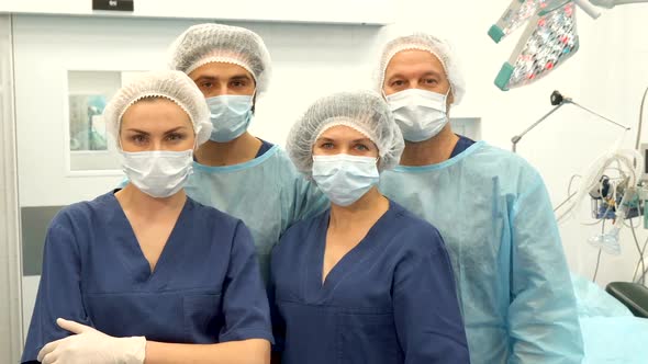 Two Surgeons and Two Nurses Pose at the Surgery Room