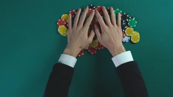 Winner Grabbing Pile of Chips After Poker Game, Greedy Man Taking All Money