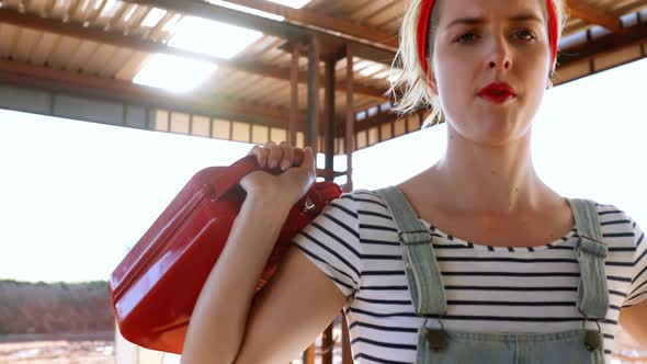 Woman holding a petrol can at petrol pump 4k