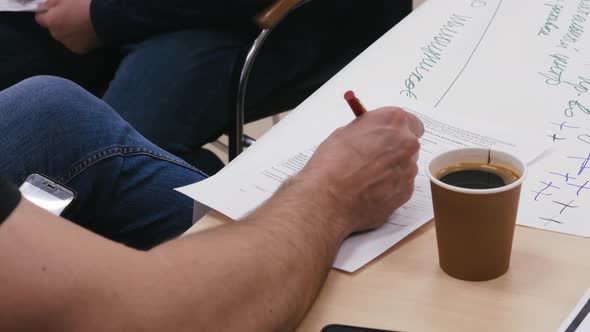 A Man Signs an Important Document About the Development of His Company