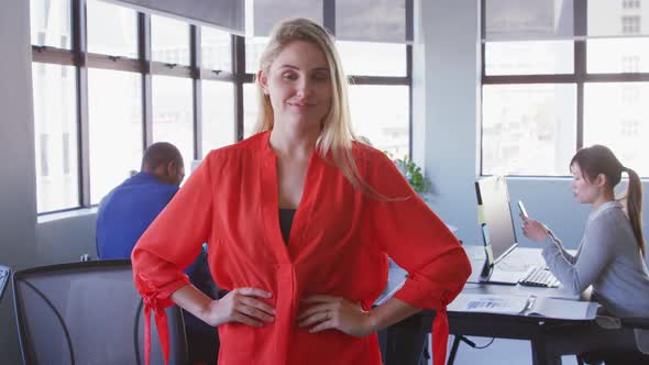 Businesswoman looking at camera in modern office