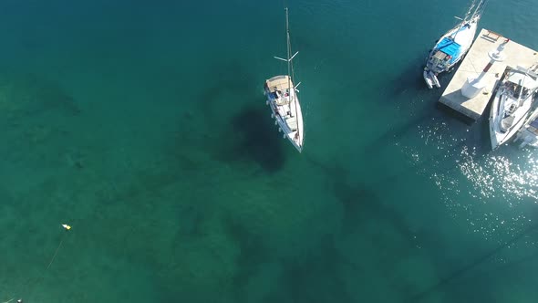 Above A Sailboat That Enters The Marina