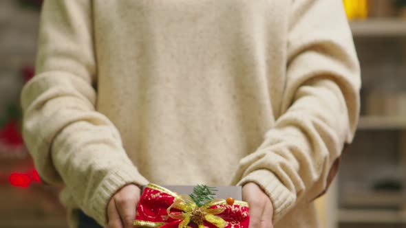 Close Up of Young Woman Showing Gift Box