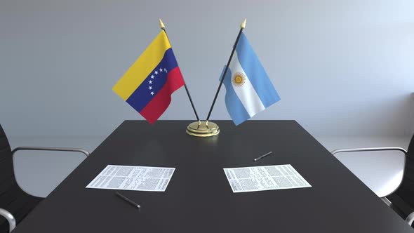 Flags of Venezuela and Argentina on the Table