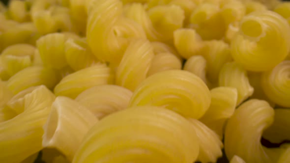 Closeup of a pile of uncooked tortiglioni pasta.