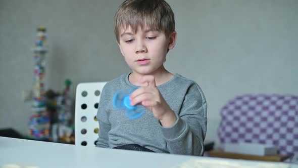 spinner is spinning in the hands of a child. The guy is messing around