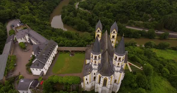 Drone Flight above German Monastery. View on river and forest.