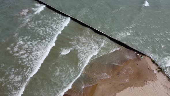 Coastal breakwater at the beach near the Grosse Point Lighthouse.  Aerial drone