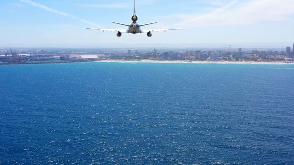 Passenger plane over the sea Heading to coast for landing, Aerial view