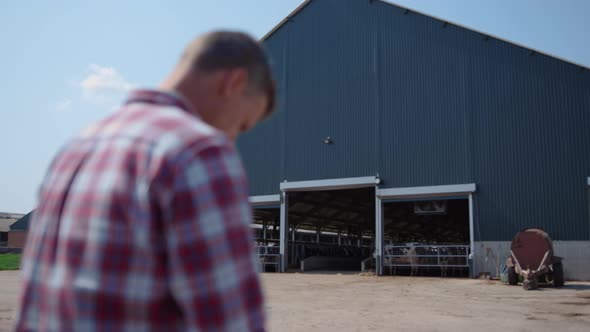 Farm Worker Sitting Outside Barn on Farmland Ranch Close Up