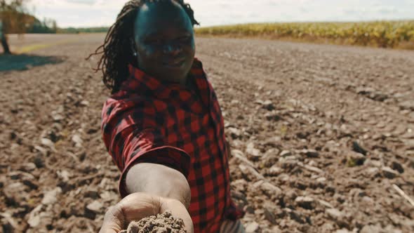 African Farmer Holding Soil in His Hand