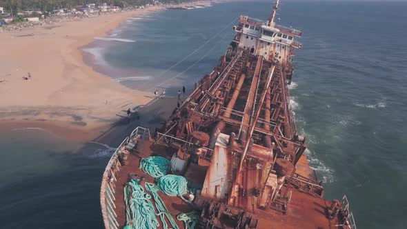 Old shipwreck on a beach near Varkala in Kerala, India. Aerial drone view