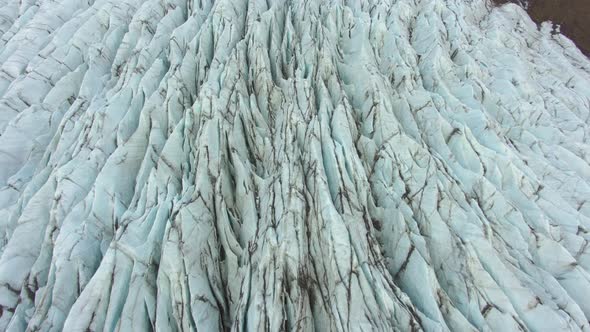 Svinafellsjokull Glacier. Ash, Cracks and Crevasses. Iceland. Aerial View