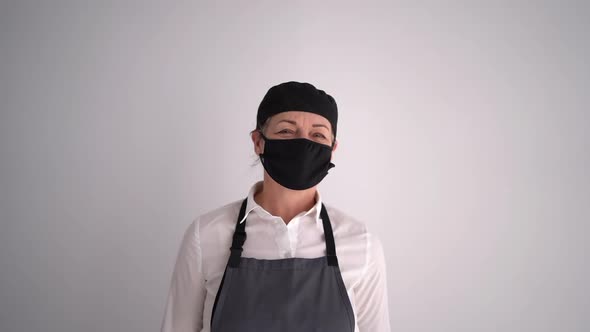 Chef Woman with Apron and Close Up Rolling Pin Pandemic and Wearing Mask Style Grey Wall Background