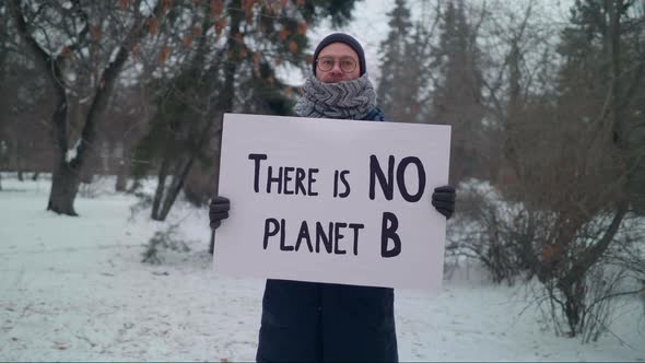 Showing the sign There Is No Planet B indicating the ecology crisis concern