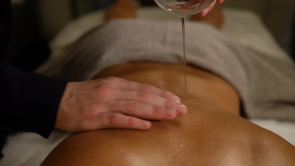 Young Beautiful Slim Woman Getting Legs Massage with Oil in Resort Spa Salon. Girl Receiving Body