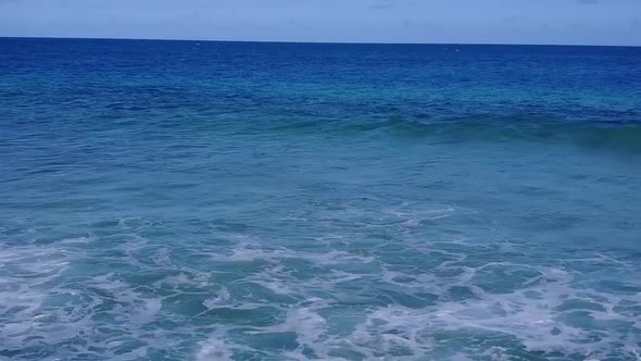 Aerial view abstract of coast beach by blue water with sand background