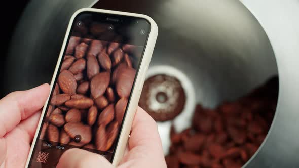 Taking Photo of Almond in Chocolate on Smartphone Camera Production of Nuts in Dark or Milk
