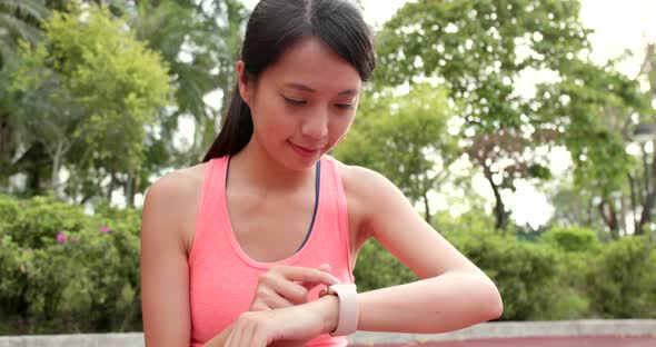 Woman use of smart watch at park